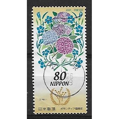 Japon 2001 : Année Mondiale Du Bénévolat : Fleurs Stylisées Symboliques, Et Emblème De L'année - Timbre Oblitéré