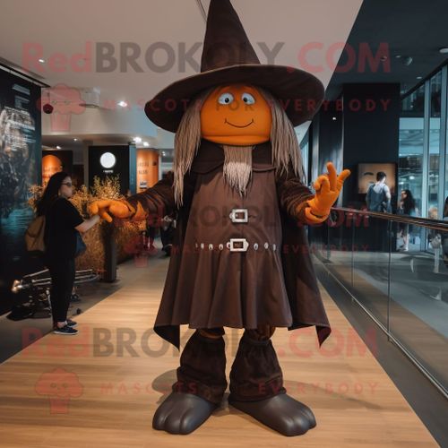 Mascotte Redbrokoly De Personnage De Sorcière Brune Habillée D'un Jegging Et De Bérets