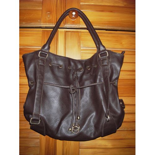 Sac À Main De Marque Nanucci De Couleur Marron ,Fermeture Zippée + Pression ,Fantaisies Sangles Libres ,Cordons De Serrage Vers Le Haut Et Au Milieu Du Sac ,Boucles ,Anneaux ,Clous De Couleur Dorés .