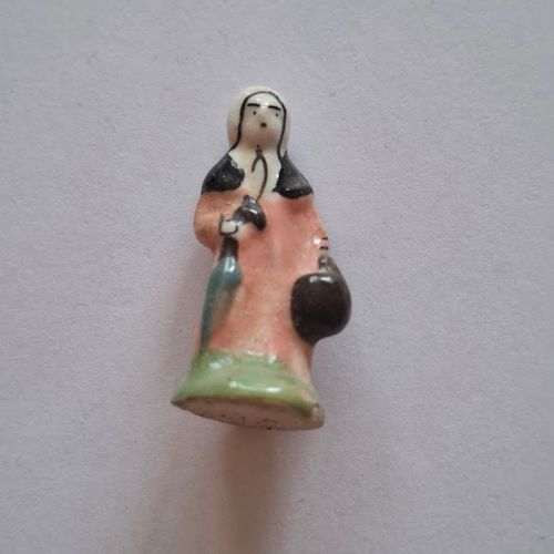 Fève - Santon - Crèche - Santon Femme Robe Rose Avec Son Parapluie Son Panier Et Son Châle Socle Vert