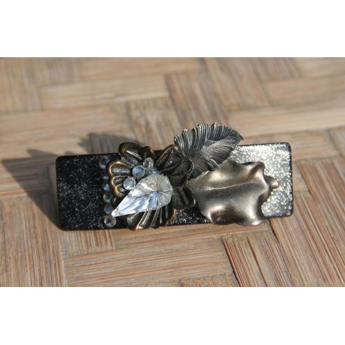 Originale Barrette Décorèe Sur Fond Noir De Feuilles Métalisèes Couleur Bronze Sur Lesquelles Reposent De Petits Brillants