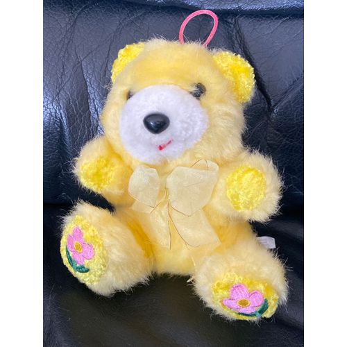Peluche doudou ours jaune fleurs rose et verte techno diffusion noeud 15cm