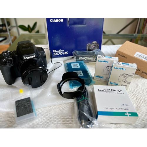 Canon Powershot SX70 HS 20.3 mpix avec tous les accessoires + pare soleil LH-DC90 + deux batteries Durapro LP-E12 avec chargeur Bridge avec un zoom exceptionnel 65X qui démarre à l'ultra grand angle de 21mm