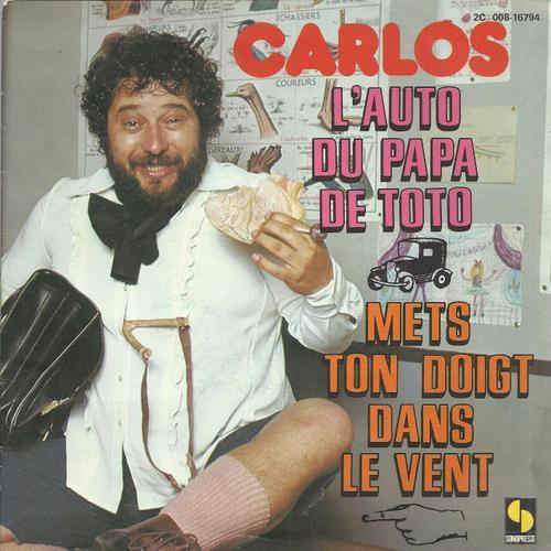 L'auto Du Papa De Toto 3'02 (Woodie Guthrie, Paroles Franaises Calude Lemesle) / Mets Ton Doigt Dans Le Vent 2'40  (Woodie Guthrie, Claude Lemesle) - Carlos