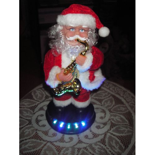 .Père-Noël automate et musical saxophoniste en habits de velours ,socle .Père-Noël automate et musical saxophoniste en habits de velours ,socle