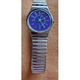 Montre Femme Marque Swatch, Bracelet Acier De 1,2 Cm, Écran 2 Cm Avec Fond Bleu-Violet. État Impeccable, En État De Marche.