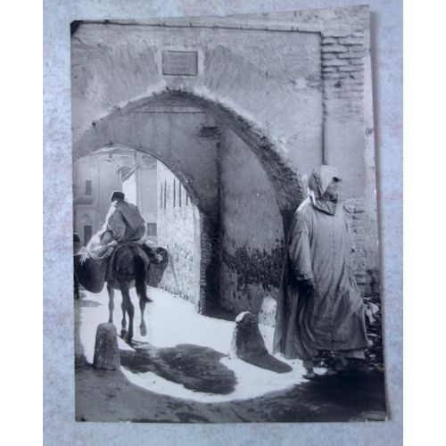 Ancienne Carte Postale Animée Cpa Du Maroc . Noir Et Blanc. "Souk Marocain, Entre 2 Arcades De Pisée Rouge". 2 Personnages, Ane. Ed Bernard Rouget.