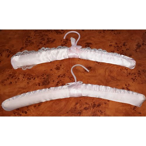Lot de 2 cintres rembourrés de tissu brillant rose avec une faveur nouée sous l'accroche plastique rose - forme légèrement courbée - longueur environ 38cm - porte-manteaux très élégants