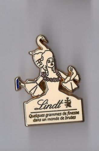 Pin's Chocolat Lindt - Quelques Grammes De Finesse Dans Un Monde De Brutes (Signé Arthus Bertrand)