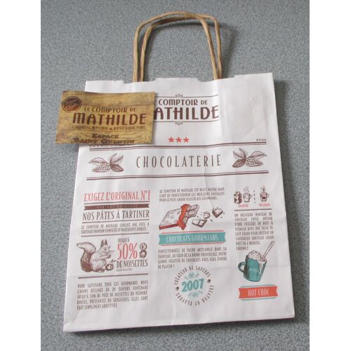 Sac Papier Publicitaire Le Comptoir De Mathilde-Chocolaterie/Epicerie Fine-2 Anses De Portage-Fond Blanc Avec Illustration Et Énumération Des Produits Vendus-Petit Modèle 18x23x8cm