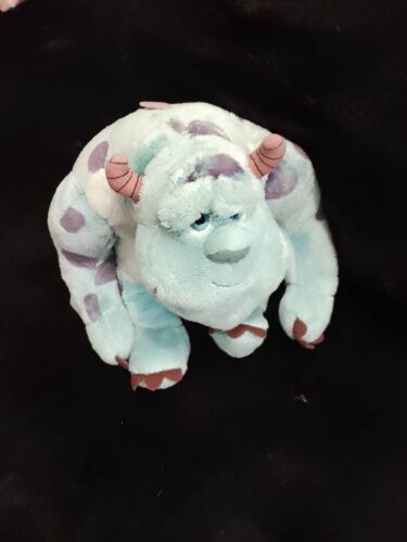 Peluche monstre gentil bleu clair/coloré Disney/Pixar.